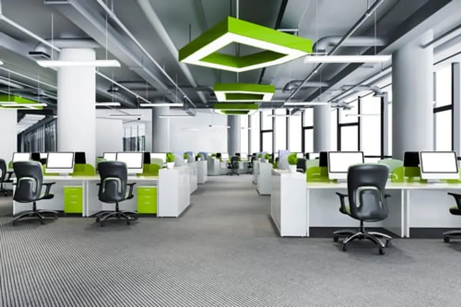 Bright modern open-plan office with clean desks, monitors, and organized workstations