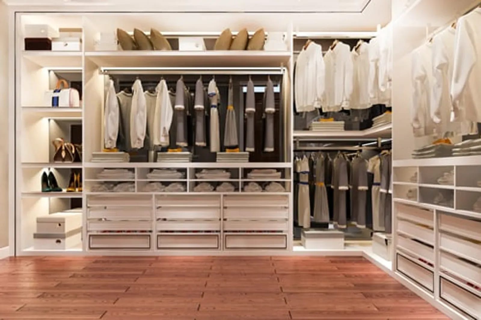 Neatly organized walk-in closet with folded clothing and labeled storage after a home organization service